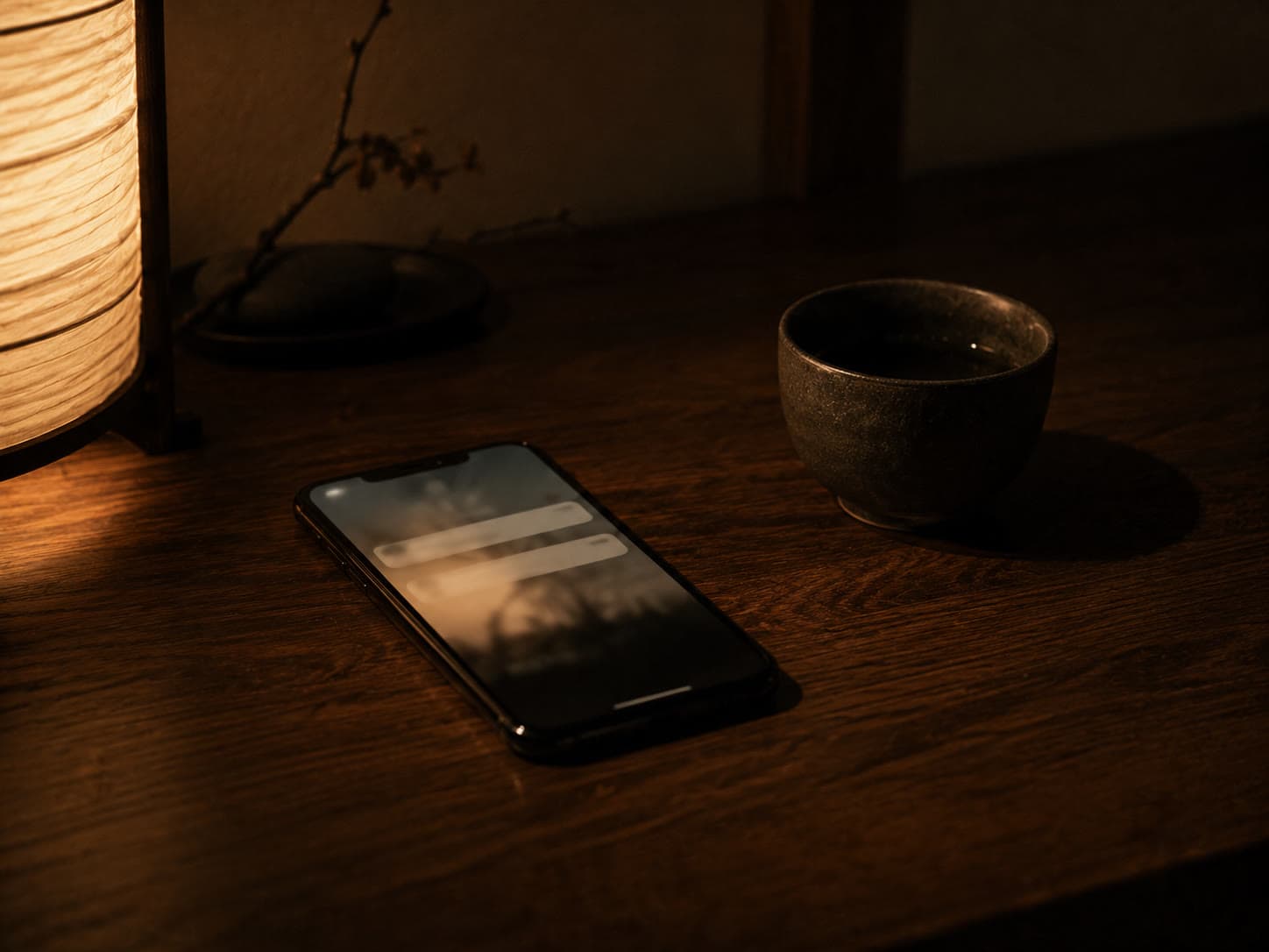 Smartphone glowing with notifications on a dark wood table